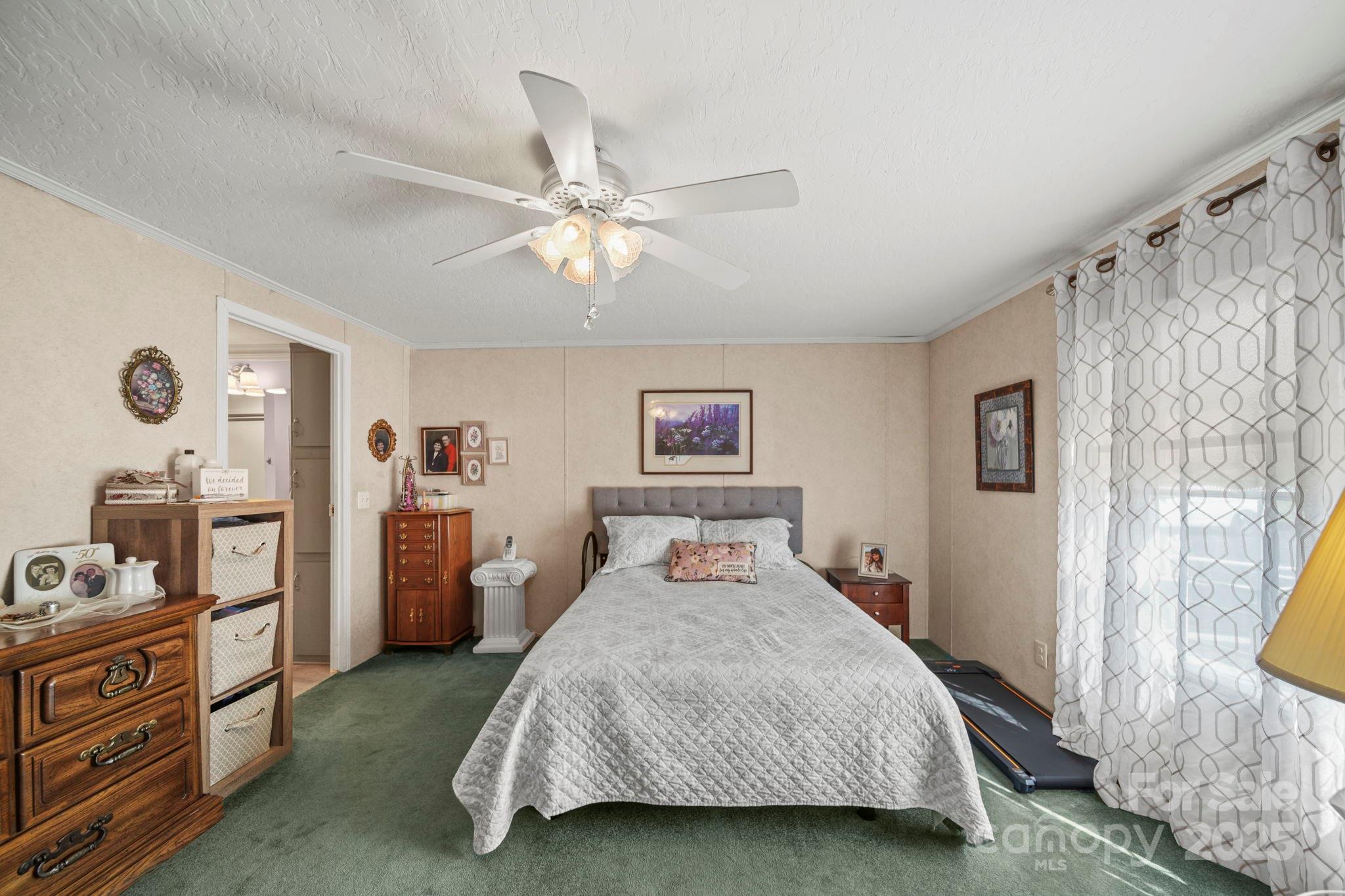 2107 Gheen Road Salisbury, NC 28147 - Photo 16 of 32 a bedroom with a bed and a chandelier