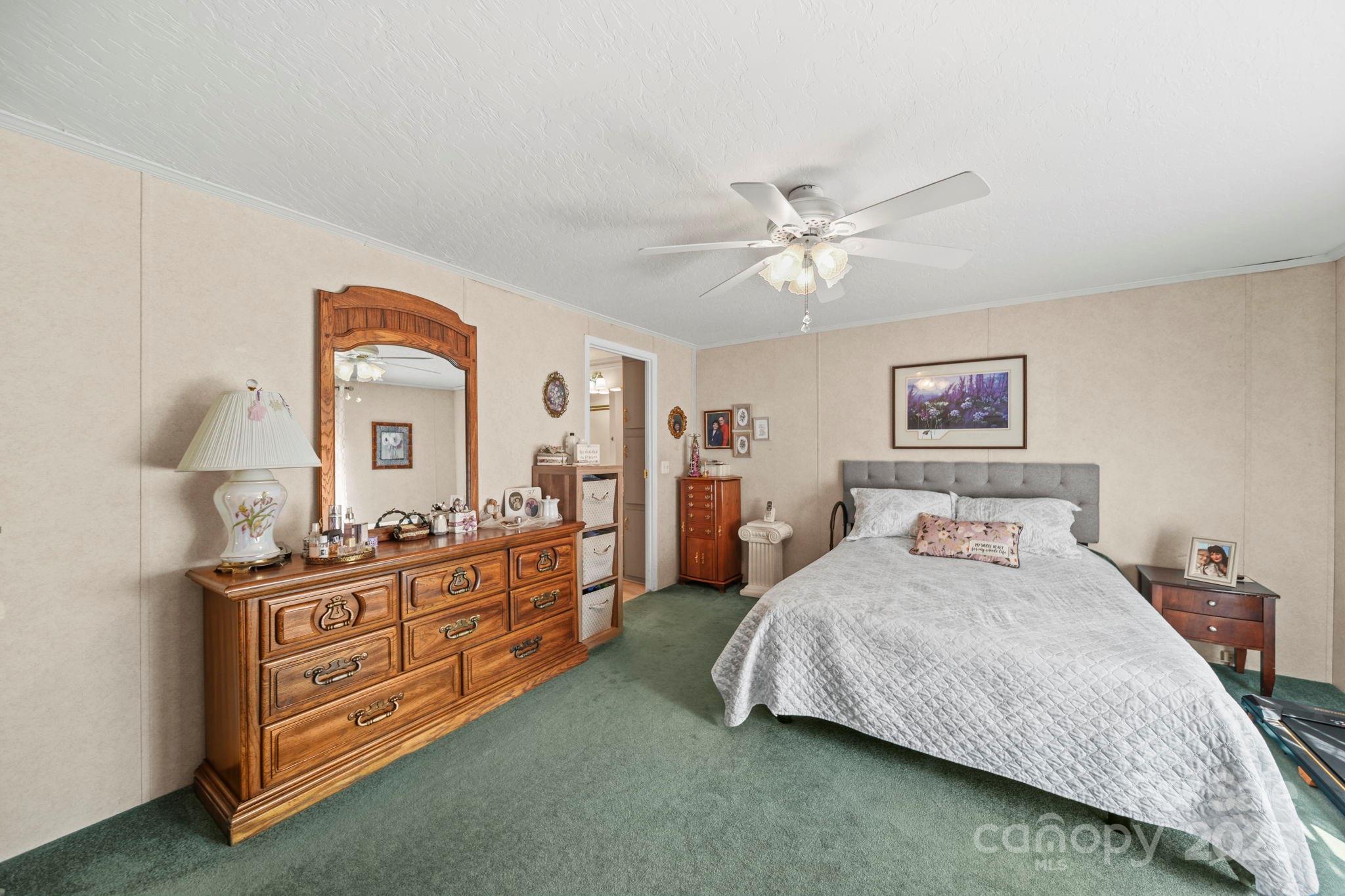 2107 Gheen Road Salisbury, NC 28147 - Photo 17 of 32 a bedroom with a bed and a chandelier