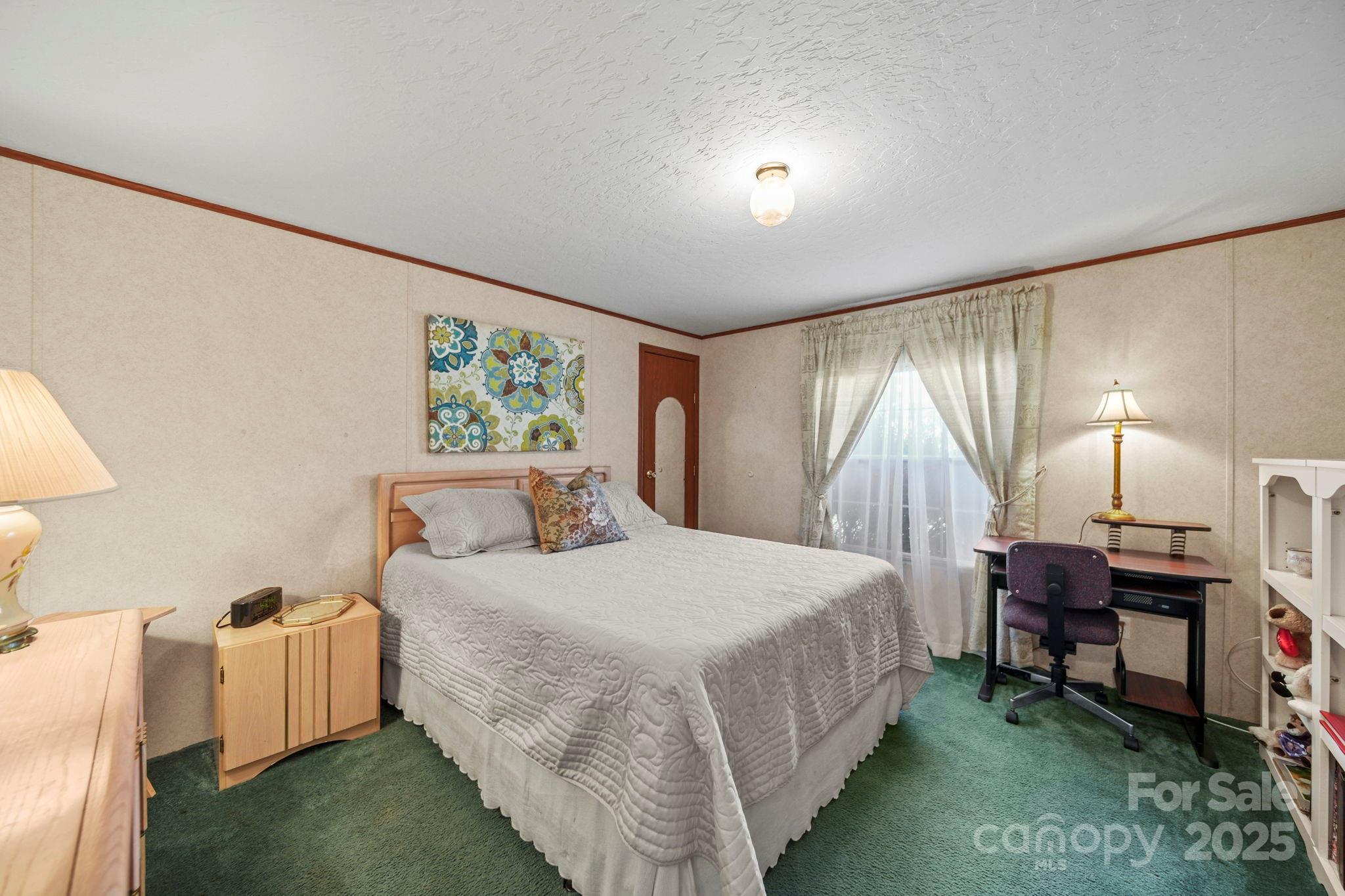 2107 Gheen Road Salisbury, NC 28147 - Photo 21 of 32 a bedroom with a bed table chair and a large window