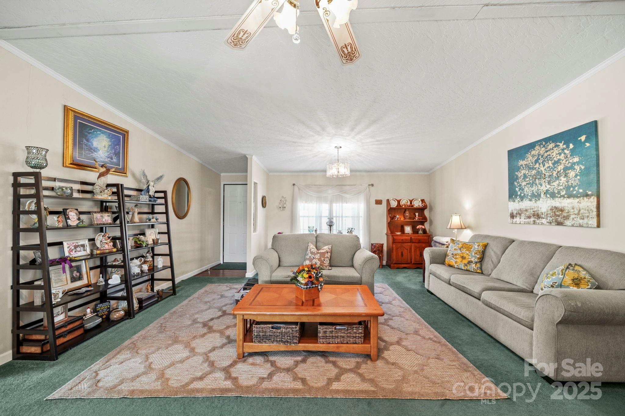 2107 Gheen Road Salisbury, NC 28147 - Photo 5 of 32 a living room with furniture a rug and a bookshelf