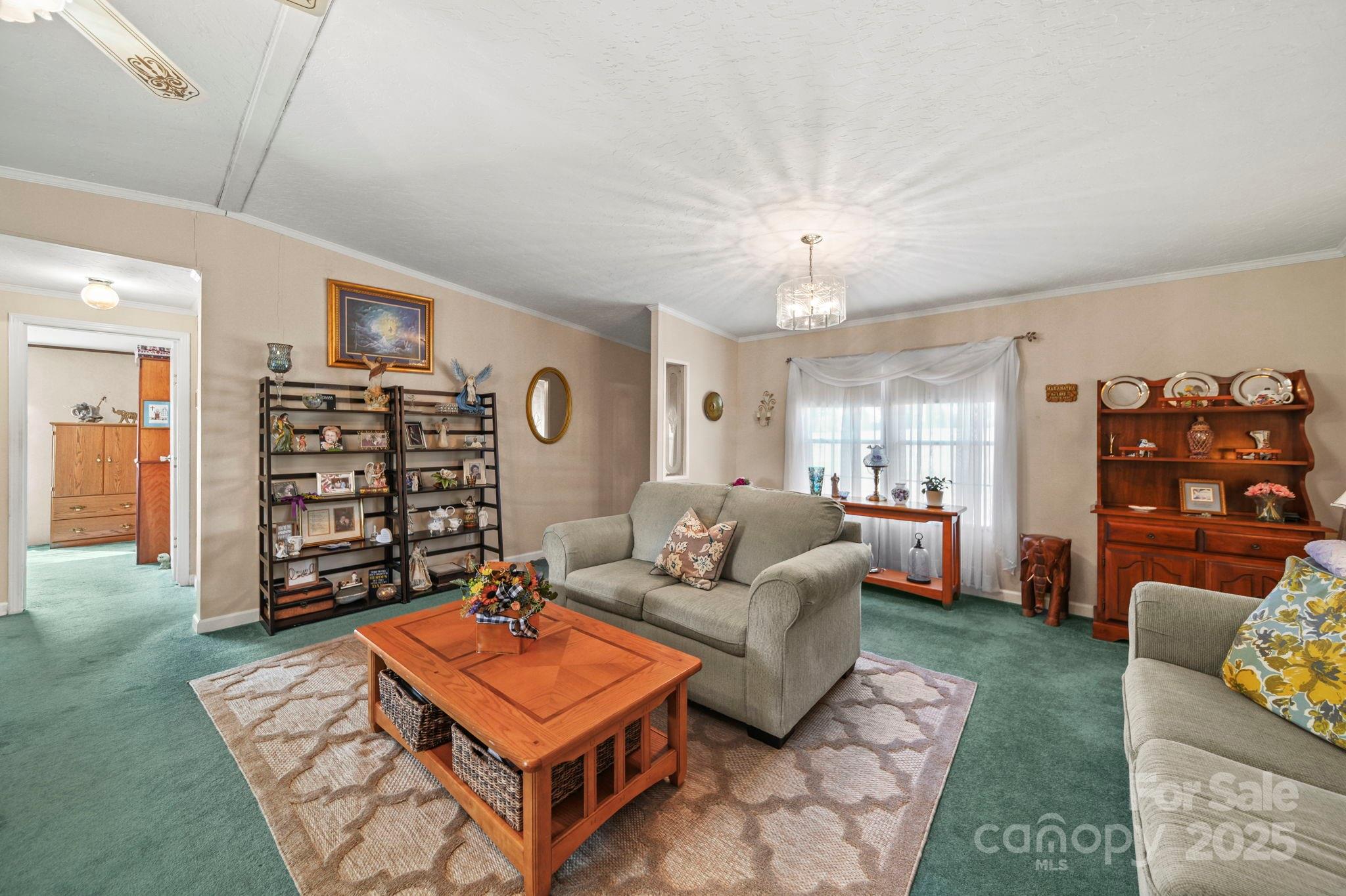 2107 Gheen Road Salisbury, NC 28147 - Photo 7 of 32 a living room with furniture a table and a bookshelf