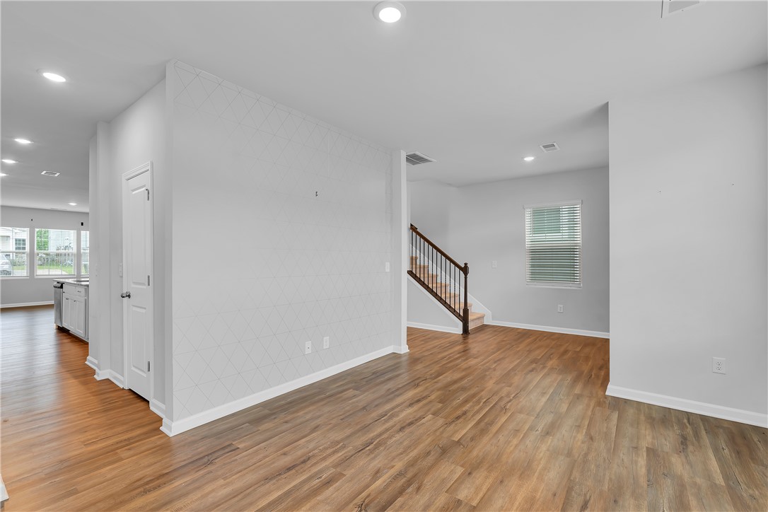 8 Leander Drive Greer, SC 29651 - Photo 15 of 31 Natural light illuminates this open-concept living space with sleek flooring and a contemporary staircase.