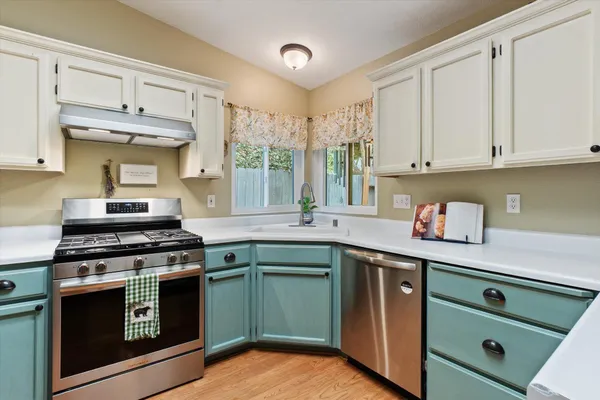 a kitchen with cabinets a sink and appliances