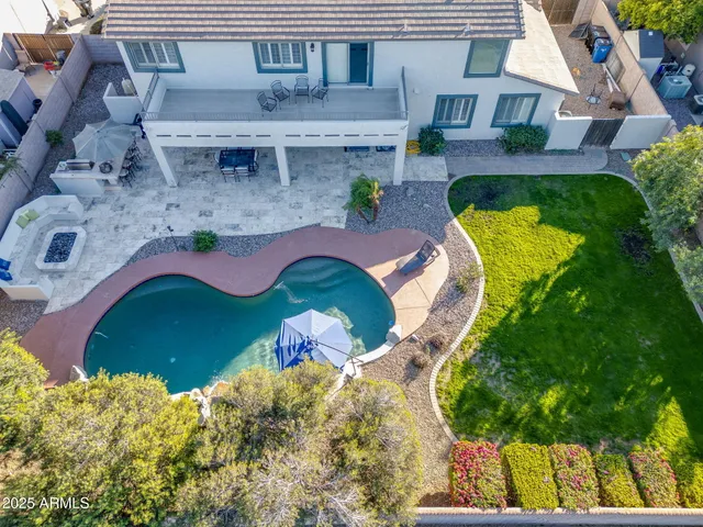 a view of a livingroom with a fireplace a chandelier and wooden floor
