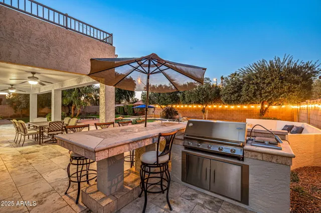 a living room with furniture and kitchen view with wooden floor
