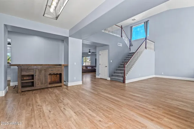 a bedroom with a large bed and windows