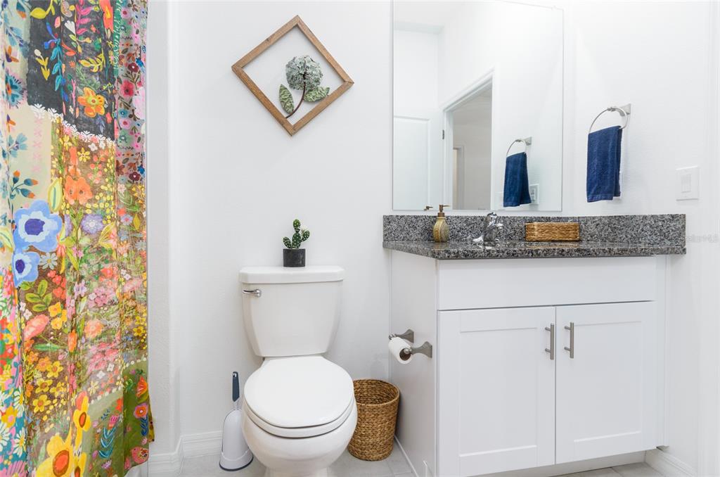 6736 Ripple Pond Loop Zephyrhills, FL 33541 - Photo 6 of 40 a bathroom with a granite countertop toilet sink and mirror