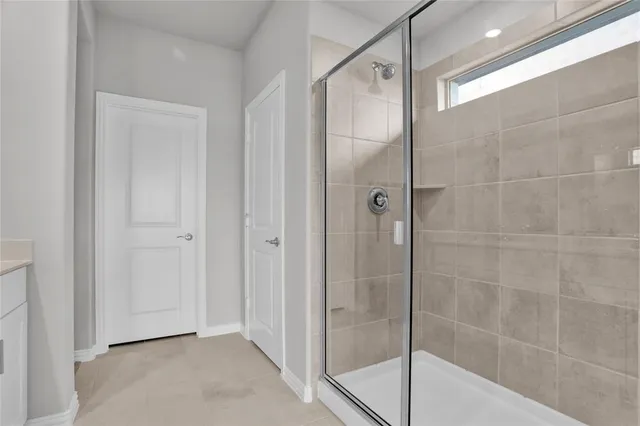a bathroom with a glass shower door