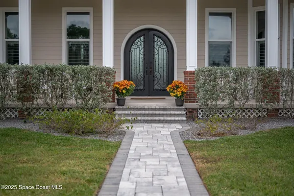 a bedroom with bed and a potted plant