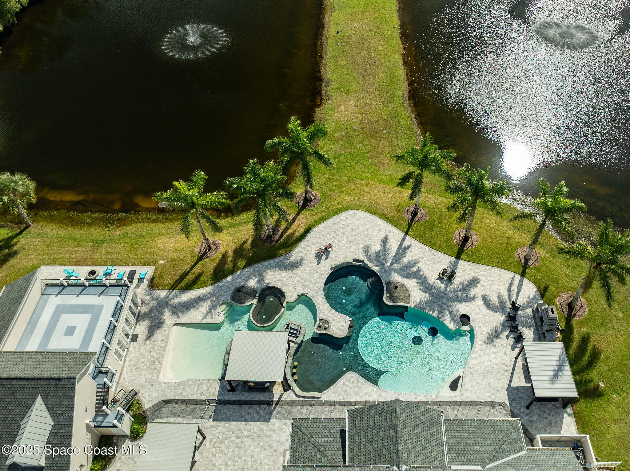 4236 Hield Road Northwest Palm Bay, FL 32907 - Photo 27 of 106 an aerial view of a house with a swimming pool