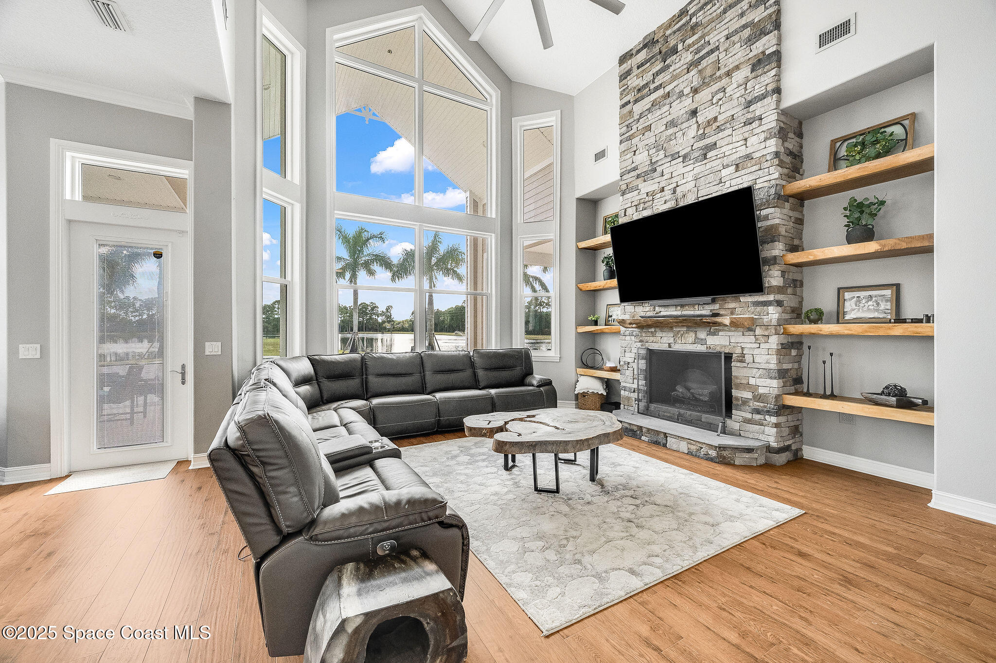 4236 Hield Road Northwest Palm Bay, FL 32907 - Photo 40 of 106 a living room with furniture a flat screen tv and a fireplace