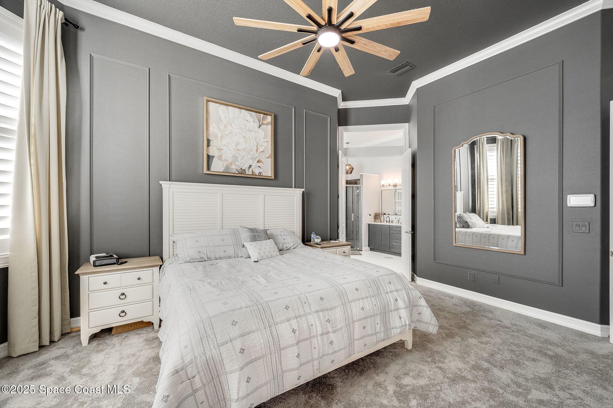 4236 Hield Road Northwest Palm Bay, FL 32907 - Photo 56 of 106 a bedroom with a bed and a chandelier fan