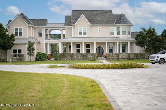 a bedroom with a bed and a chandelier fan