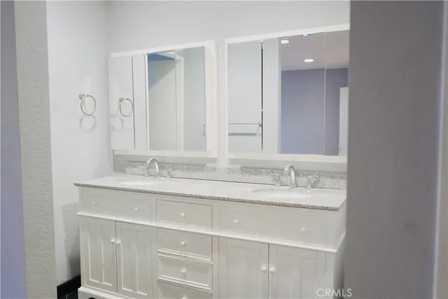 a view of an empty room with closet and wooden floor
