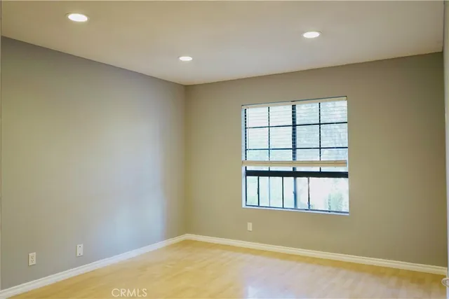 a view of an empty room with a fireplace and a window