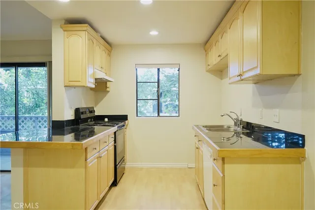 a kitchen that has a sink and a stove