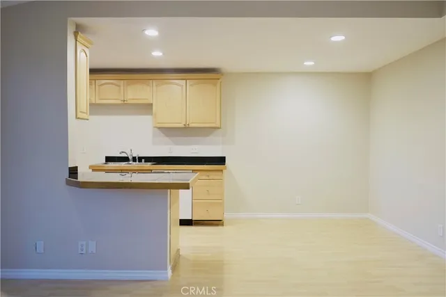 a view of kitchen with granite countertop cabinets and window