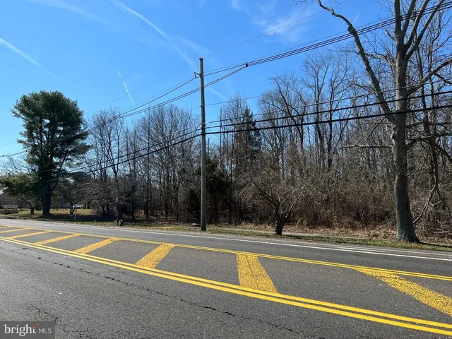 a view of a tennis court with a small house
