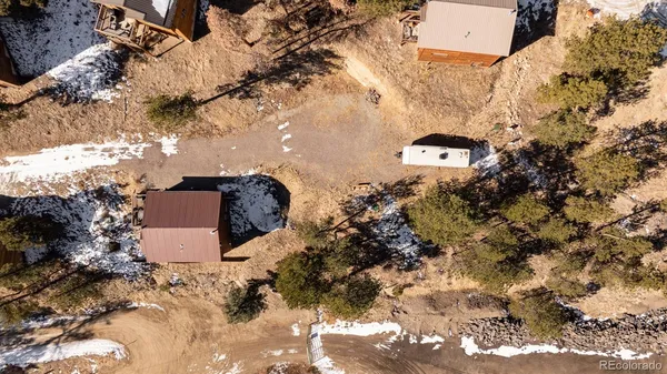 an aerial view of a house with a yard