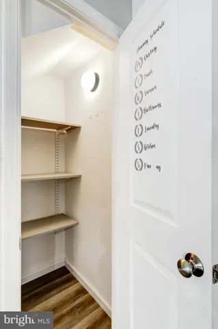 an empty room with windows and ceiling fan