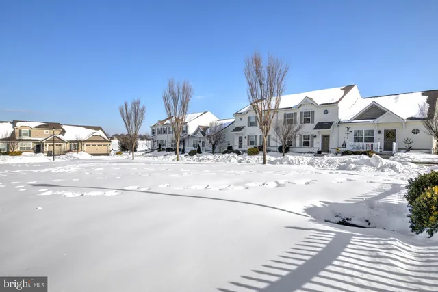 a view of a building with a snow on the road