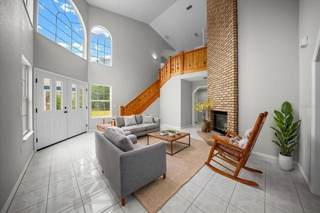 a living room with patio furniture and a fireplace