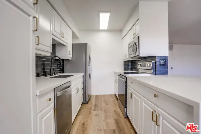 a stove top oven sitting inside of a kitchen