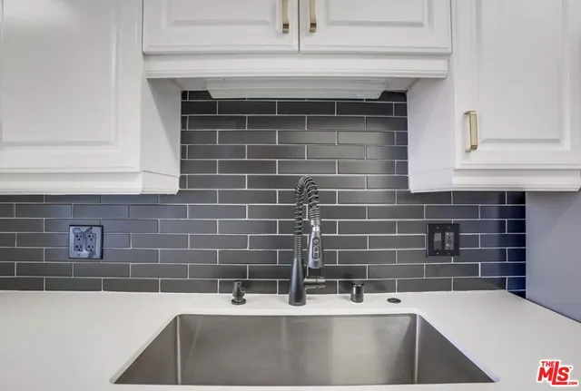 a view of kitchen with wooden floor and electronic appliances