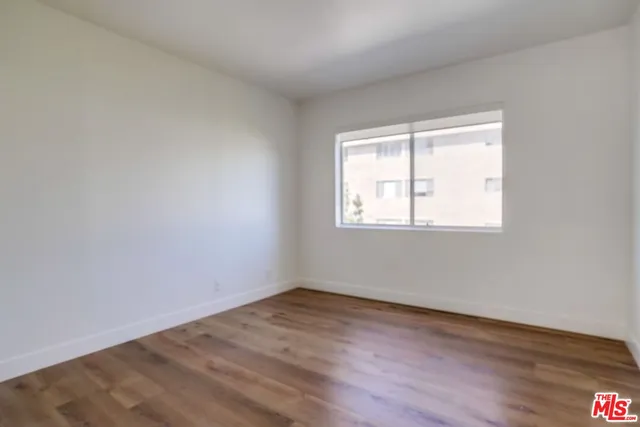 a view of a patio with couches table and chairs with potted plants and big yard