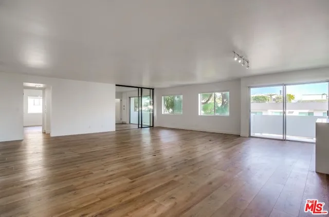a view of wooden floor and windows in an empty room
