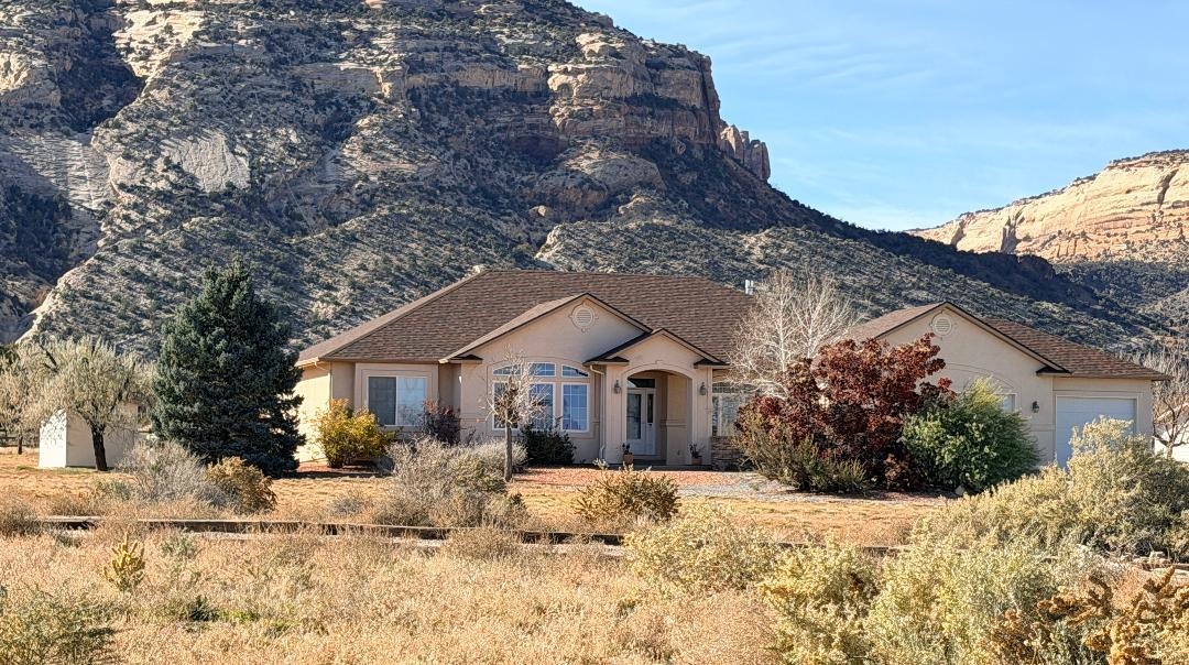 2297 Shiprock Road Grand Junction, CO 81507 - Photo 12 of 12 a front view of a house with a yard covered in snow