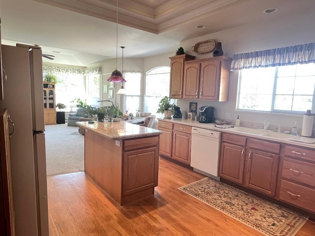 2297 Shiprock Road Grand Junction, CO 81507 - Photo 6 of 12 a kitchen with stainless steel appliances granite countertop a stove a refrigerator a sink and dishwasher with wooden floor