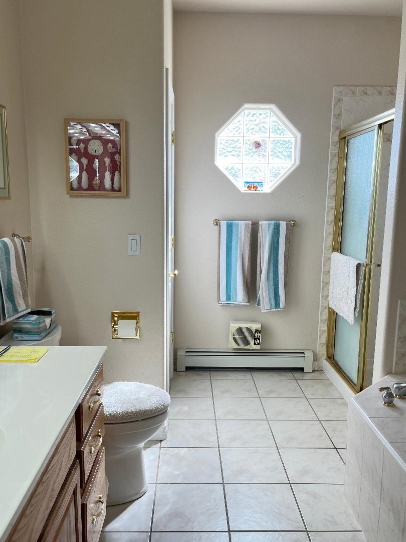 2297 Shiprock Road Grand Junction, CO 81507 - Photo 10 of 12 a living room with a couch and a chandelier