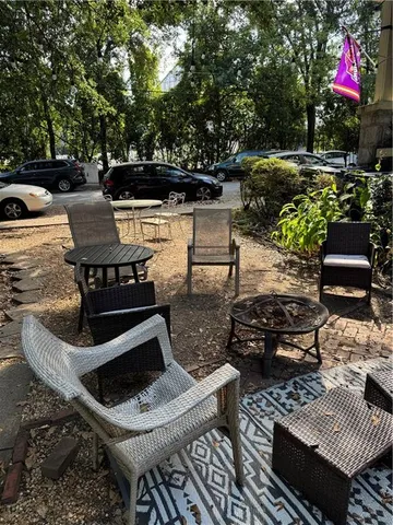 a view of a house with a cars park side of a road