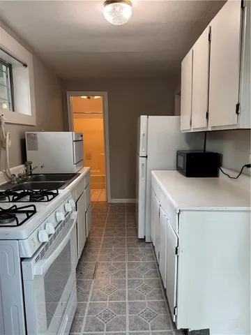 a kitchen with a stove and a refrigerator