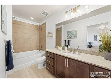 a bathroom with a tub sink toilet and a mirror