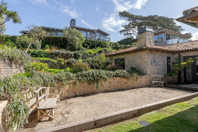 a view of staircase with lots of frames on wall and a chandelier