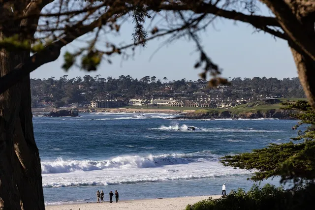 a living room with furniture a fireplace and a large window