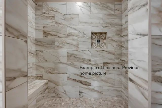 a view of a room with an empty space and wooden floor