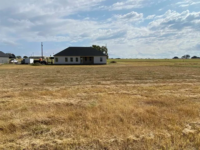 a kitchen with kitchen island stainless steel appliances a sink refrigerator and microwave