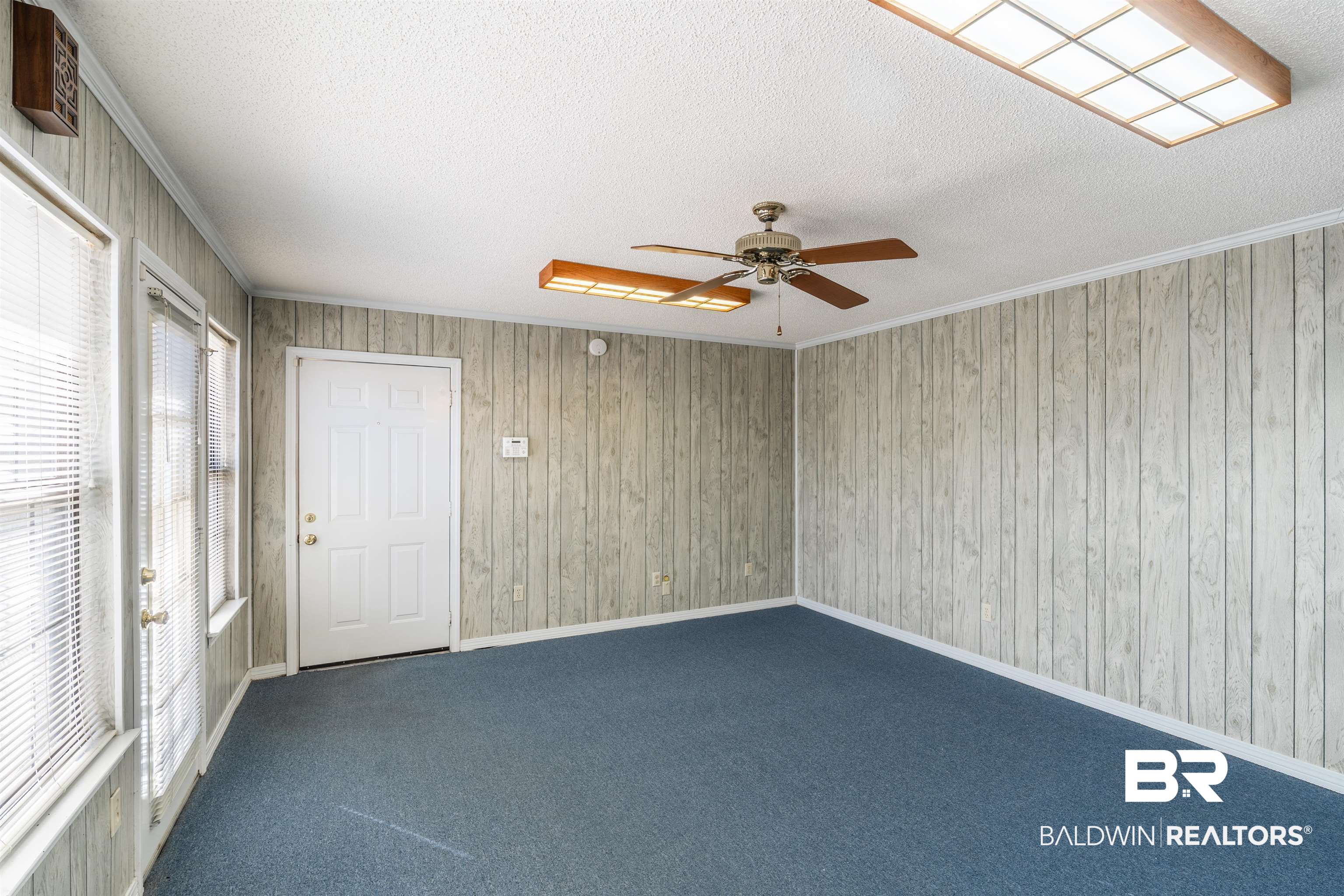 9751 Pine Knoll Road Mobile, AL 36608 - Photo 14 of 36 Empty room featuring a ceiling fan, carpet floors, a textured ceiling, and ornamental molding