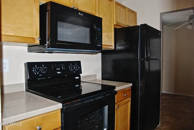 a kitchen with stainless steel appliances granite countertop a refrigerator and a microwave