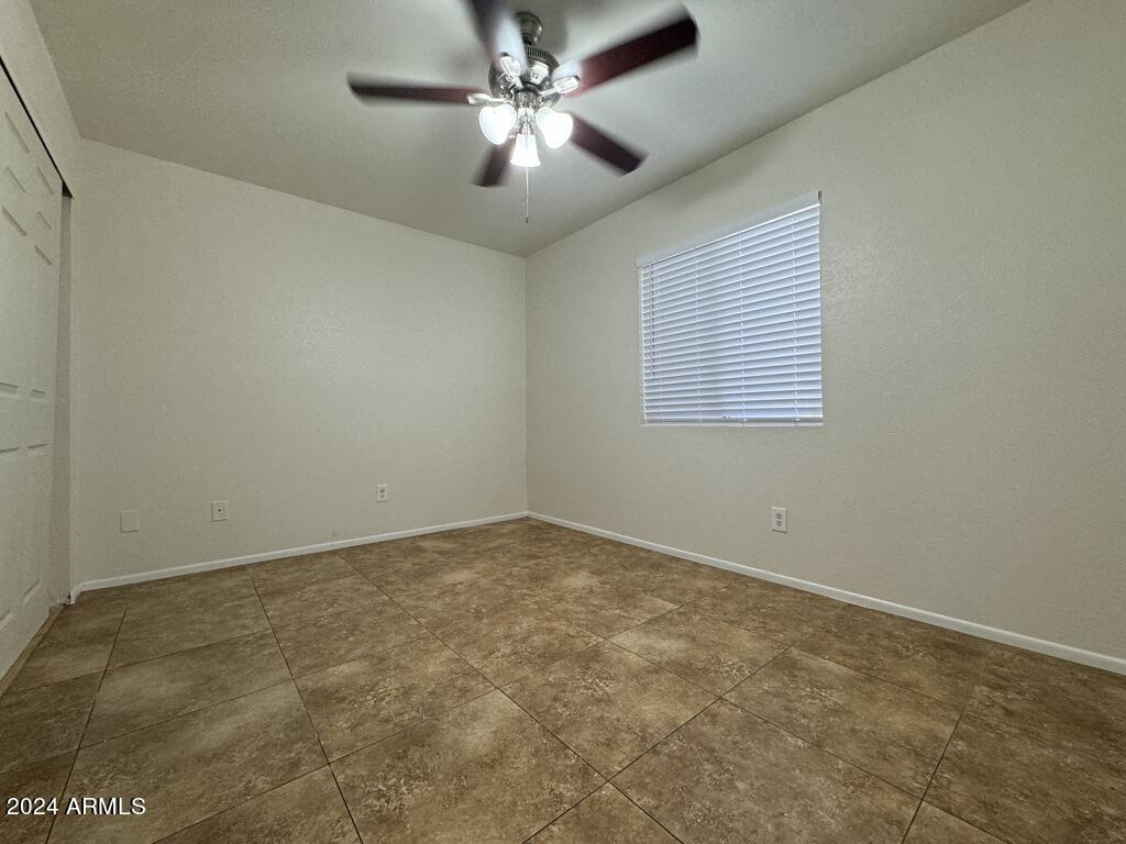 7550 North 12th Street, Unit 121 Phoenix, AZ 85020 - Photo 11 of 21 an empty room with a window and a fan