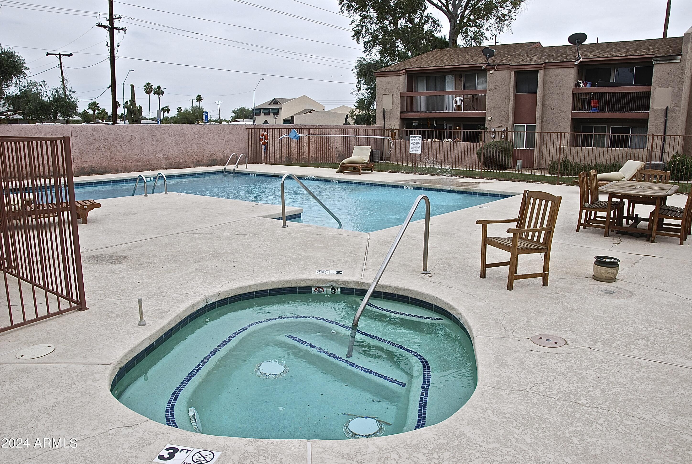 7550 North 12th Street, Unit 121 Phoenix, AZ 85020 - Photo 17 of 21 a swimming pool with outdoor seating and barbeque oven