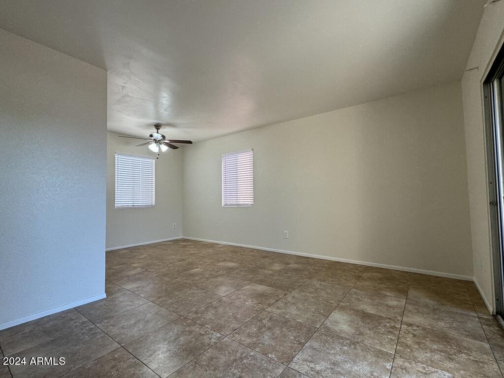 7550 North 12th Street, Unit 121 Phoenix, AZ 85020 - Photo 6 of 21 an empty room with windows and ceiling fan view
