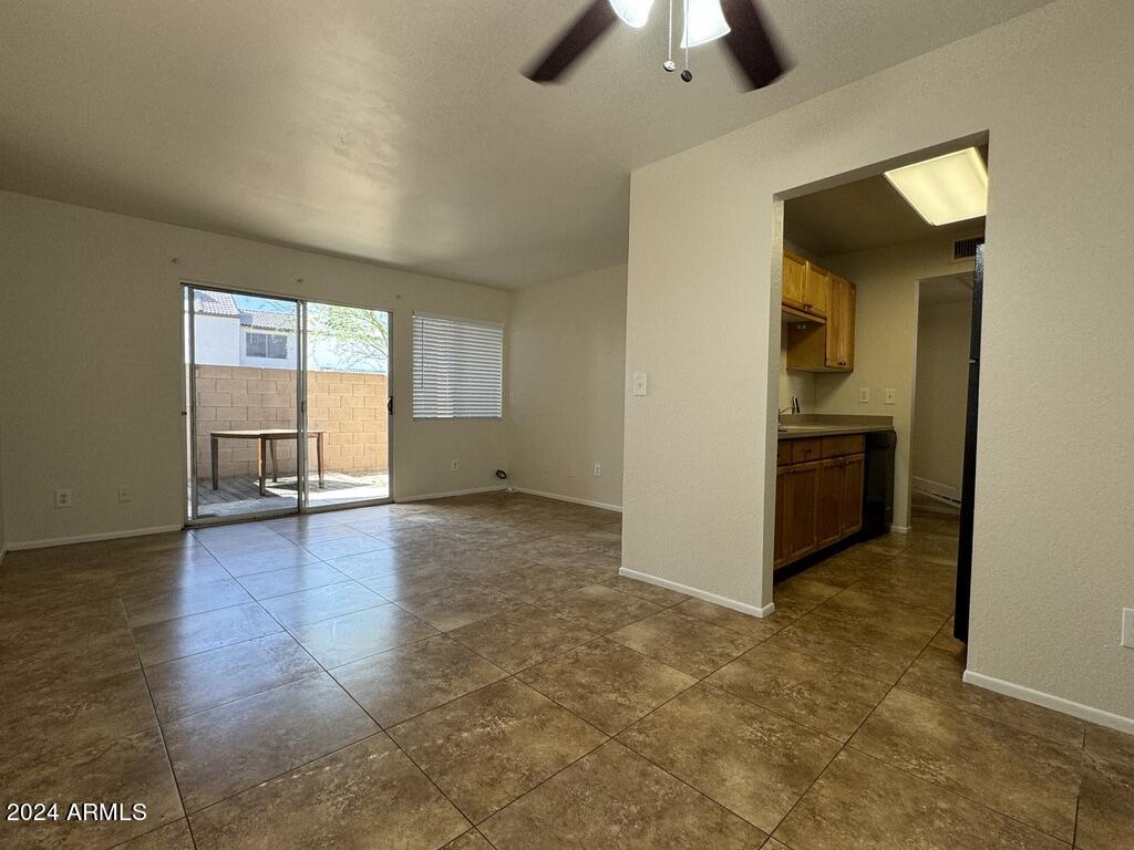 7550 North 12th Street, Unit 121 Phoenix, AZ 85020 - Photo 8 of 21 an empty room with chandelier fan and windows
