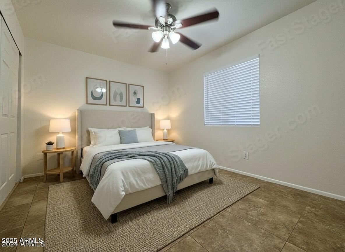 7550 North 12th Street, Unit 121 Phoenix, AZ 85020 - Photo 10 of 21 a bedroom with a bed and a chandelier