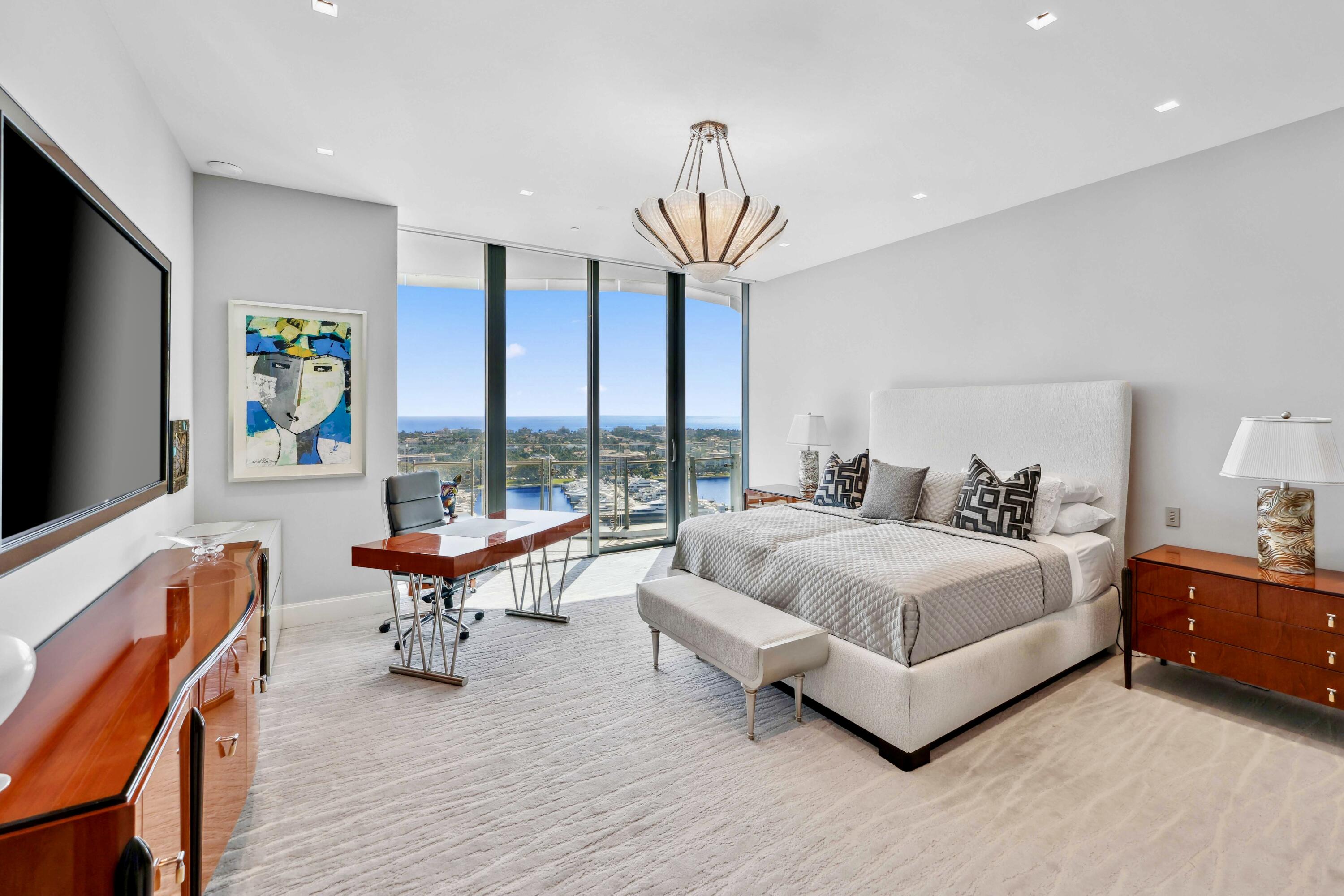 1100 South Flagler Drive, Unit 1801 West Palm Beach, FL 33401 - Photo 19 of 56 a spacious bedroom with a bed and a flat screen tv