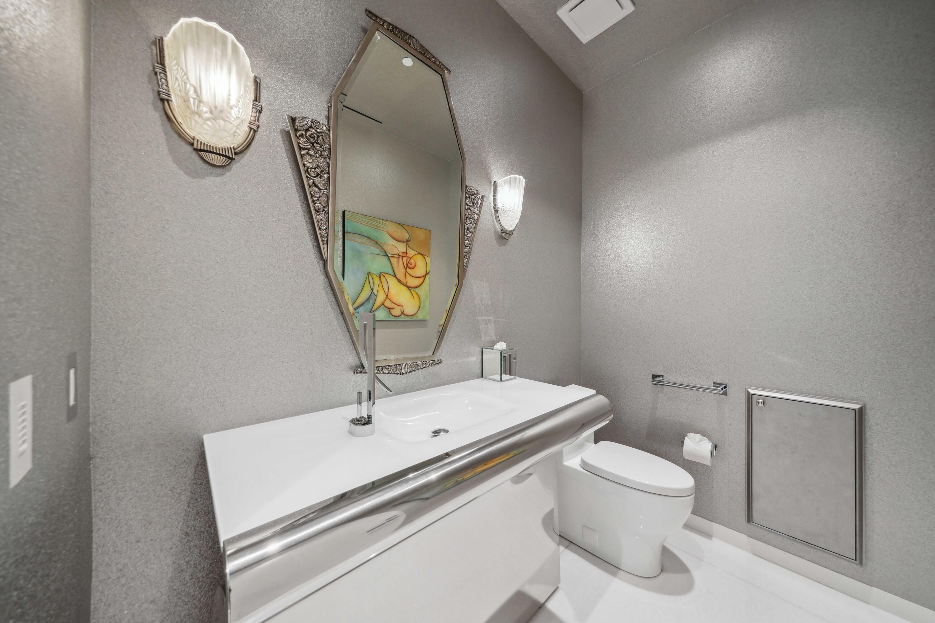 1100 South Flagler Drive, Unit 1801 West Palm Beach, FL 33401 - Photo 33 of 56 a bathroom with a sink mirror and toilet