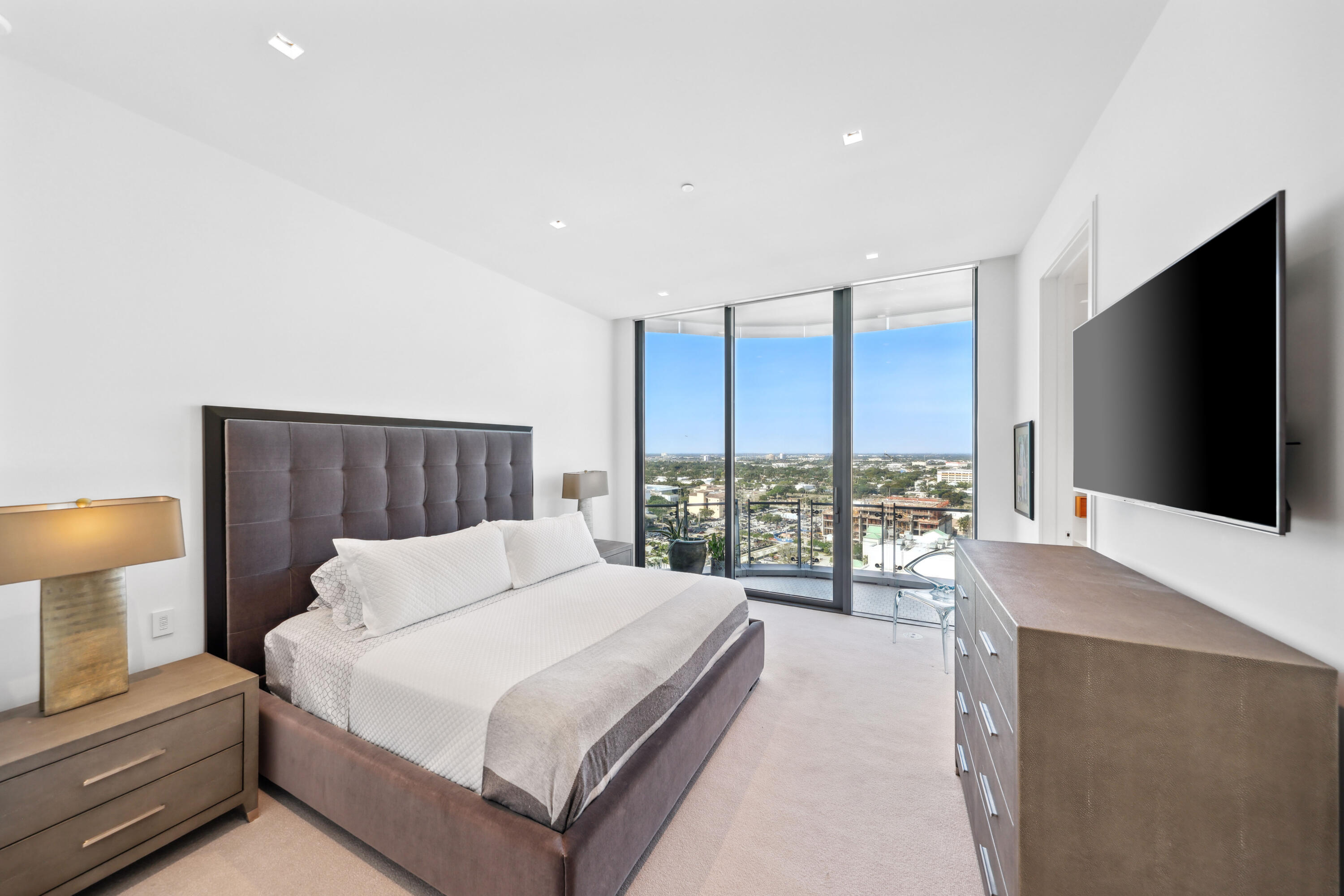 1100 South Flagler Drive, Unit 1801 West Palm Beach, FL 33401 - Photo 39 of 56 a bedroom with a large bed and a flat tv screen on dresser